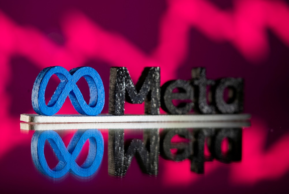 FILE PHOTO: A 3D printed Facebook’s new rebrand logo Meta is seen in front of displayed stock graph in this illustration