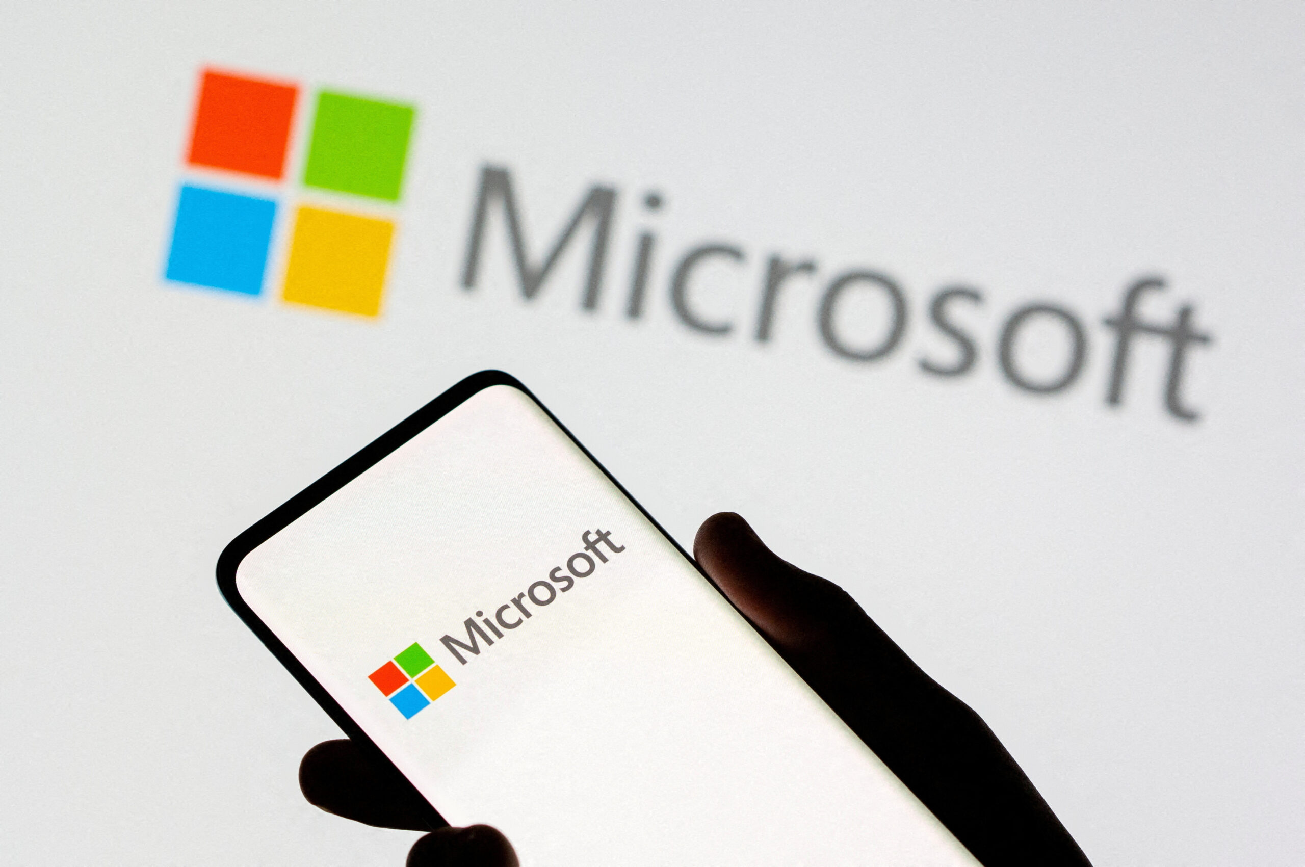 FILE PHOTO: Smartphone is seen in front of Microsoft logo displayed in this illustration taken