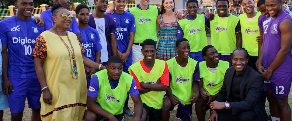 The Princess alongside the Prince of Wales and Sterling (third from right) with a group of footballers in Jamaica Credit WireImage
