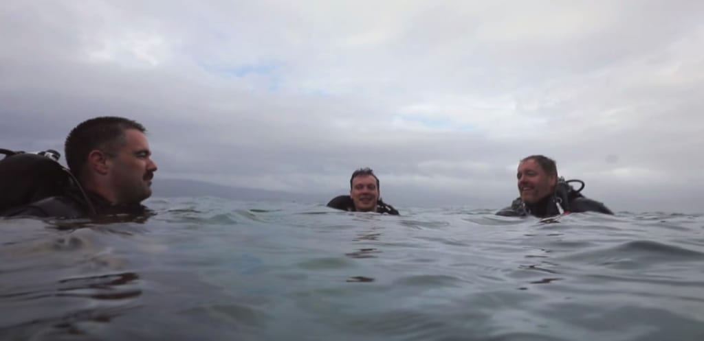 Josh Marano (left), AJ Van Slyke and Josh Gates float at the surface of the water during an underwater archaeology expedition in Jamaica. Photo courtesy of Discovery Channel.
