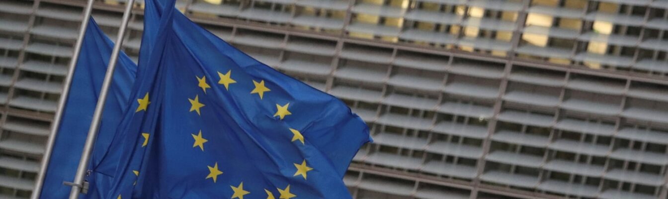 EU flags flutter outside the European Commission headquarters in Brussels