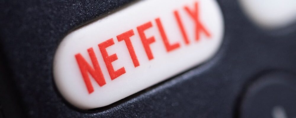 The Netflix logo is seen on a TV remote controller, in this illustration