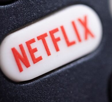 The Netflix logo is seen on a TV remote controller, in this illustration