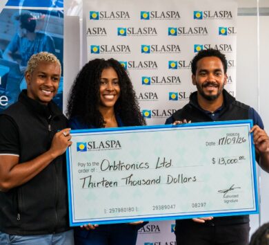 Photo 2 - Orbtronics receiving check from Silver Sponsor, Saint Lucia Air and Seaport Authority (SLASPA)