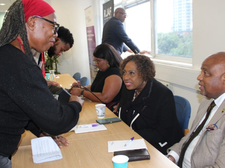 Karen greeting Jamaican government minister Olivia Grange