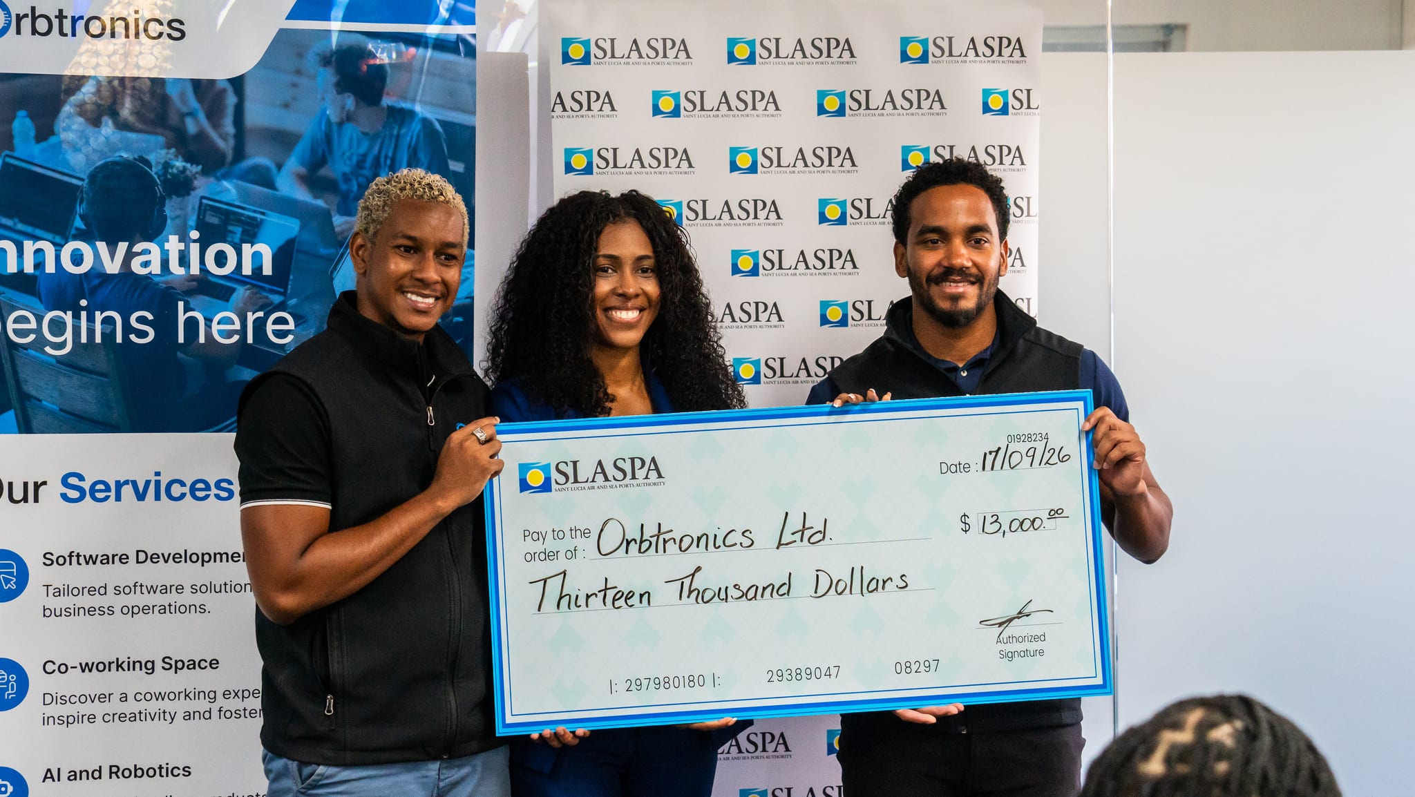 Photo 2 - Orbtronics receiving check from Silver Sponsor, Saint Lucia Air and Seaport Authority (SLASPA)