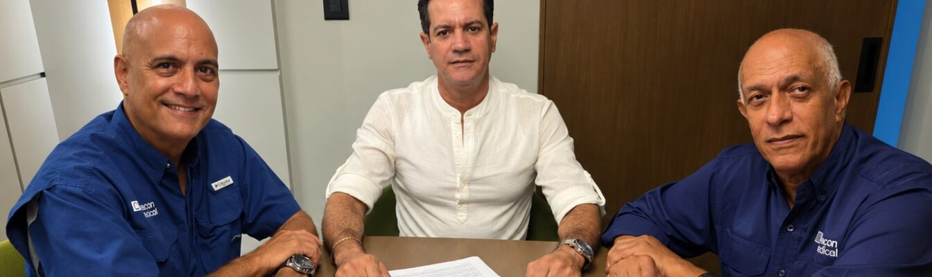 Men signing documents at a table