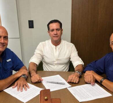 Men signing documents at a table