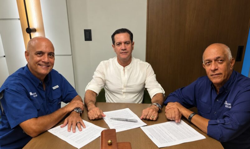 Men signing documents at a table