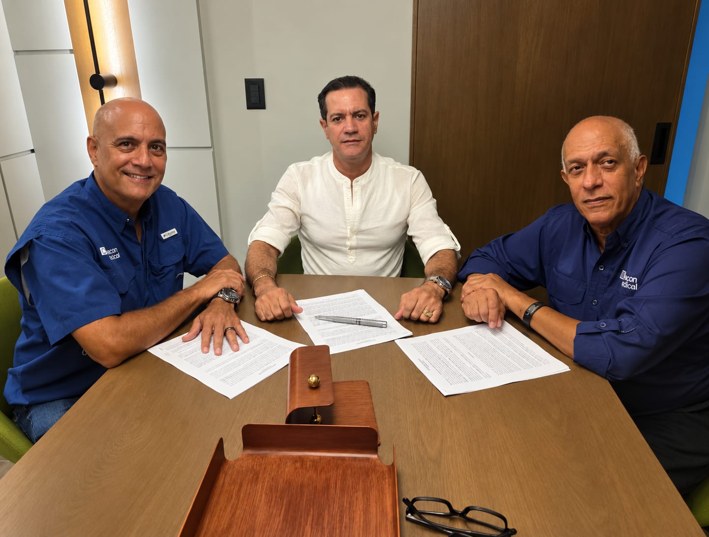 Men signing documents at a table
